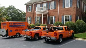 Fire Damage Restoration At Residential Job Site fire damage restoration trucks at a job site